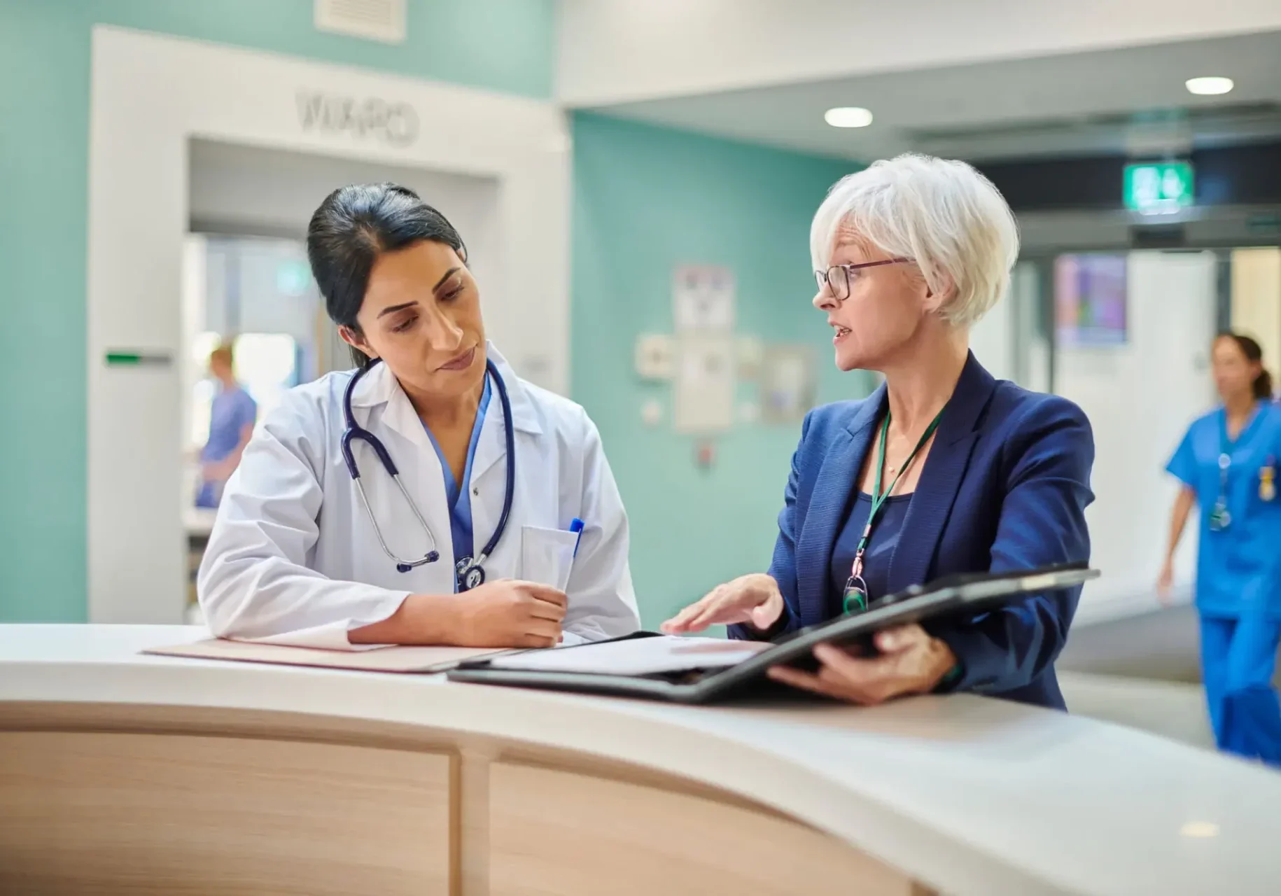 Doctor and patient discussing medical information in clinic.